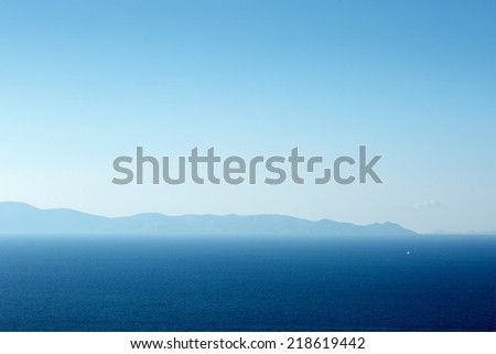 Clear blue background of the sea off the coast of Santorini. Greece on a sunny day. The air is hazy.