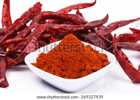 chili powder and dried chili on a white background. image suitable for food products, restaurants, fresh goods store, wholesaler and seller of the product chilies or chili based health products