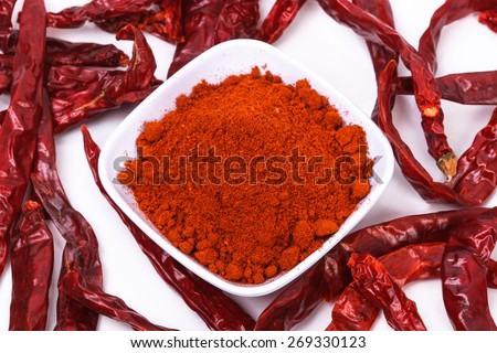 chili powder and dried chili on a white background. image suitable for food products, restaurants, fresh goods store, wholesaler and seller of the product chilies or chili based health products