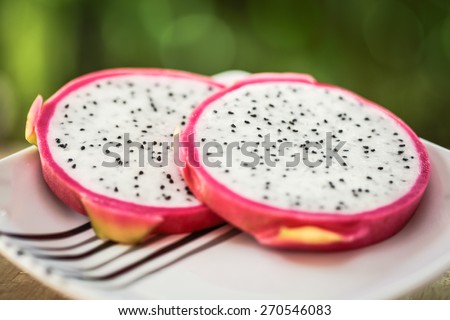 Dragon Fruit in natural light with blurred background effect of trees in the garden. image suitable for restaurants, supermarkets, wholesalers, resellers Dragon Fruit products or health products