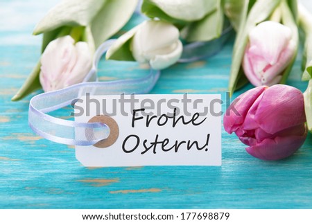 Tag with the german words Frohe Ostern which means Happy Easter and tulip on turquoise background