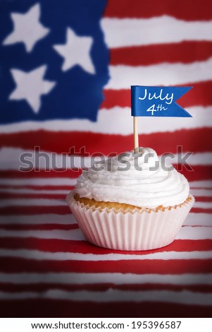A Cupcake with a July 4th Flag on an American Flag Background