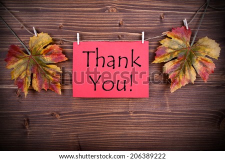 Red Label with Thank You with Autumn Leaves on a Line