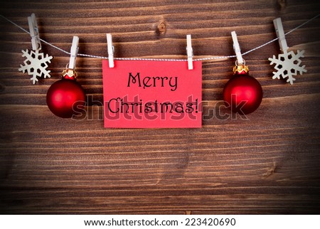 The Words Merry Christmas on a red Banner Hanging on a Line