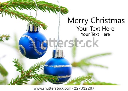 Green Christmas Fir Tree With Two Blue Christmas Balls Whith Silver Decoration On It And Your Text Here, White Background, Merry Christmas