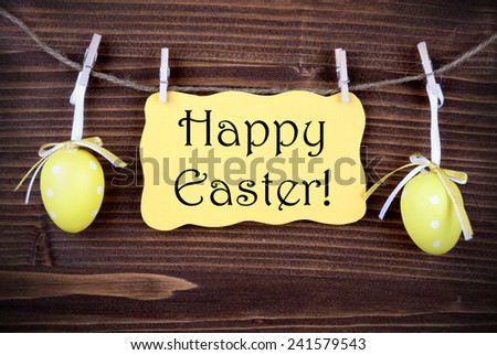 Yellow Easter Label With Happy Easter Hanging On A Line With Two Yellow Easter Eggs On Wooden Background, Vintage,  Old Fashion, Rustic Or Retro Style And Frame