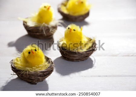 Easter Baskets With Yellow Feathers And Four Easter Chicks Sunny Light With Copy Space Free Text Or Your Text Here For Happy Easter Greetings Or Easter Decoration Close Up Or Macro Wooden Background