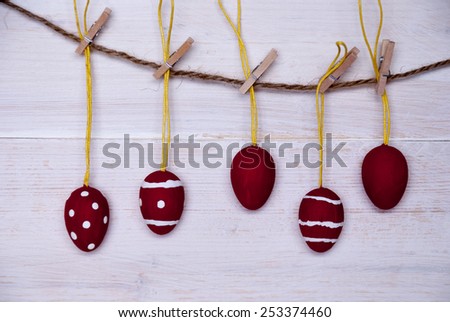 Five Red And White Easter Eggs Hanging On A Line Which Are Dotted And Striped On White Wooden Vintage Or Rustic Background For Easter Greetings And Happy Easter