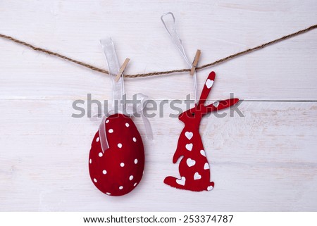 A Red Easter Bunny With Hearts And A Big Easter Egg Which Is Dotted And With A Loop And Ribbon Hanging On A Line On White Wooden Vintage Or Rustic Background For Easter Greetings And Happy Easter