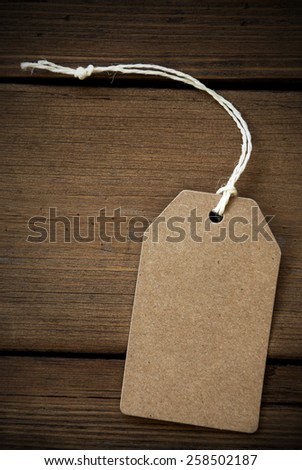 Close Up Of A Brown Label With White Ribbon On Wooden Background For Copy Space Or Free Text Or Your Text Here Frame And Vintage Or Retro Style Vertical Format