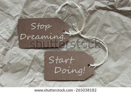 Two Brown Labels Or Tags With White Ribbon On Crumpled Paper Background With English Life Quote Stop Dreaming Start Doing Vintage Or Retro Style