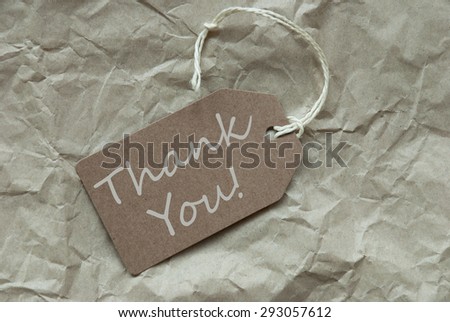One Beige Label Or Tag With White Ribbon On Crumpled Paper Background With English Text Thank You Vintage Or Retro Style