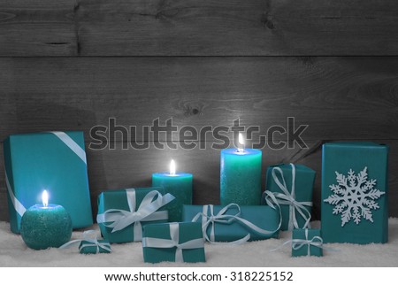 Christmas Decoration With Turquoise Candles, Handmade Christmas Gifts, Presents, Snowflake, Snow.Peaceful Atmosphere With Candlelight. Wooden,Vintage,Rustic Background.Copy Space.Black And White Image