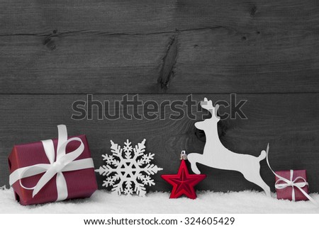 Christmas Card With Red Festive Decoration On White Snow. Gift, Present, Reindeer, Christmas Ball, Snowflakes. Brown, Rustic, Vintage Wooden Background. Copy Space For Advertisement. Black and White