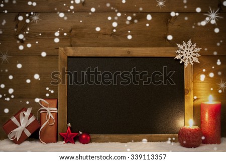 Festive Christmas Card With Chalkboard, Red Gifts Or Presents, Christmas Balls, Snowflakes And Candles. Christmas Decoration With Rustic, Vintage Brown Wooden Background. Copy Space For Advertisement