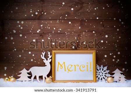 Christmas Card With Picture Frame On White Snow. French Text Merci Means Thank You. White Decoration Like Snowflakes, Tree, Golden Balls And Reindeer. Vintage, Wooden Background