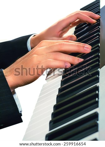 Hands of musician. Pianist playing on a synthesizer, isolated on a white background