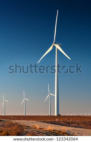 Tall wind turbine in a West Texas cotton field.  Part of a larger wind farm.