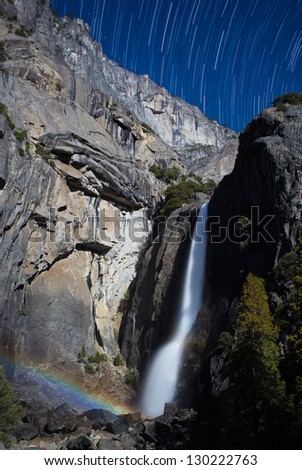 Moonbow and star trails at Yosemite Lower Falls during a full moon