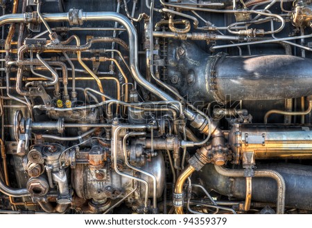 The pipes and mechanical systems of an aircraft jet engine.  Would make a great steam punk background.