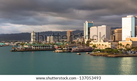View of the Honolulu Port skyline as the sun lights up the buildings
