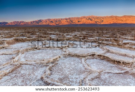 Salt polygons form natural patterns during sunrise at Badwater Basin in Death Valley National Park