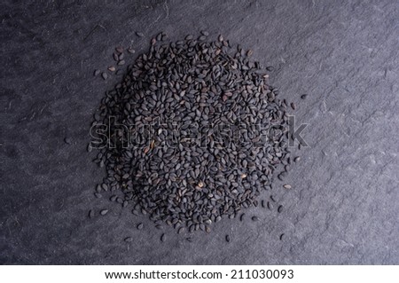 Black sesame seeds on black background