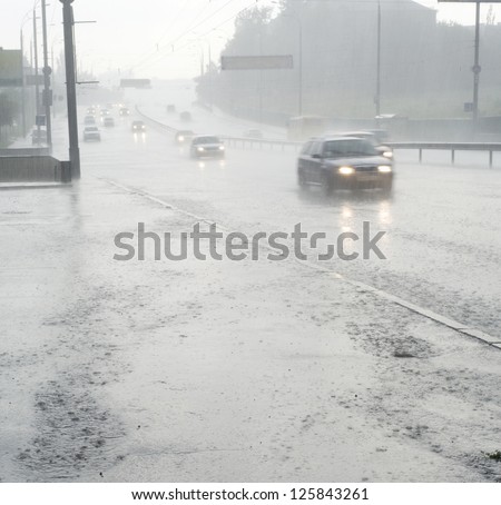 On the wet road with fast approaching cars