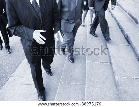 Businessmans went up  stairs. businessmens on their way to the office