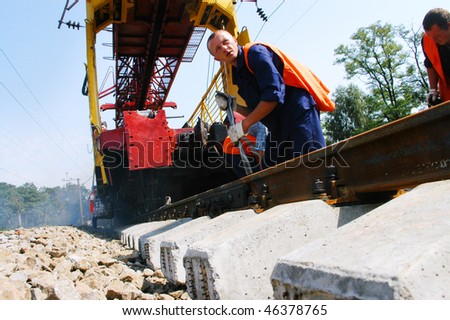 KIEV REGION, UKRAINE - AUGUST 21: Repair workers modernize the 1,000th km of Irpin-Bucha railway line on August 21, 2007  in Kiev region, Ukraine