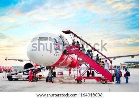 KUALA LUMPUR - MAY 14: Boarding on AirAsia  Jet airplane in Kuala Lumpur airport on May 14, 2013 in Kuala Lumpur. Its been named as world\'s best low-cost airline, operates scheduled flights to 78 destinations
