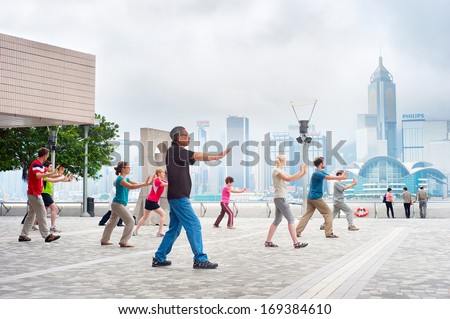 Hong Kong - May 15: Tai Chi Exercising In The Morning On May 15, 2013 In Hong Kong. With A Land Of 1,104 Km And Population Of 7 Million, Hong Kong Is One Of Most Densely Populated Areas In The World