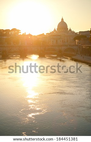 View of Tiber and St. Peter\'s cathedral at sunset in Rome