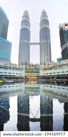 KUALA LUMPUR - MARCH 15, 2013: Petronas Twin Towers  reflected in a pool in Kuala Lumpur. Petronas Twin Towers is the tallest twin buildings in the world.