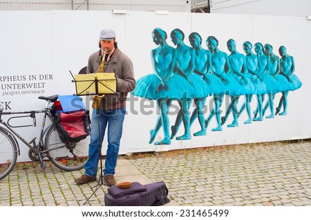 BERLIN, GERMANY - NOVEMBER 15, 2014: Unedentified musician playing music on the Berlin street.