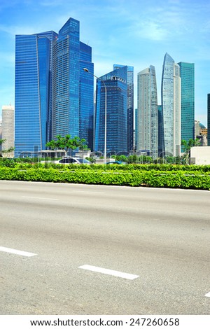Urban road in Singapore. Downtown Core of Singapore on the background