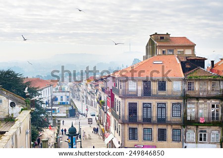 PORTO, PORTUGAL - JAN 14, 2015: People walking on the street of Porto Downtown. Porto, also known as Oporto, is the second-largest city in Portugal.