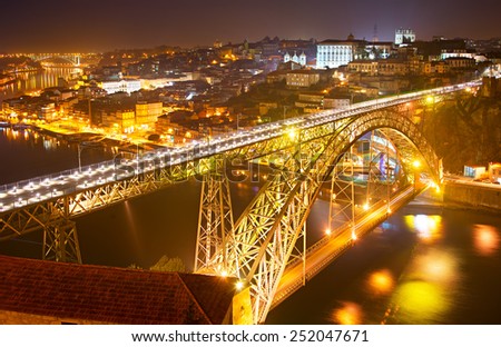 Famous Dom Luis I bridge at night. Old Town of Porto on the background. Portugal