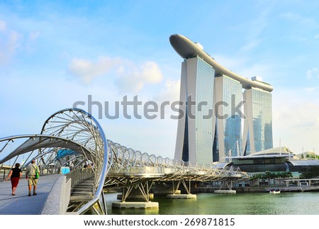 SINGAPORE - MAY 03, 2013 : The Helix Bridge and Marina Bay Sands in Singapore. Marina Bay is billed as the world\'s most expensive standalone casino property at S$8 billion