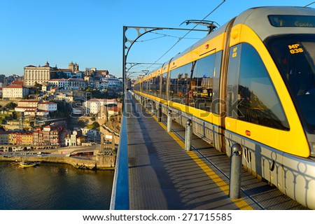 PORTO, PORTUGAL - JAN 12, 2015: Modern light rail tram over the Dom Luis bridge in Porto city, Portugal.