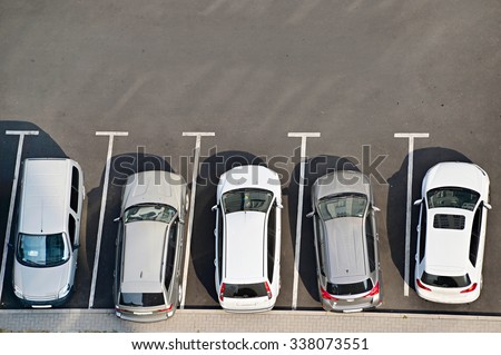 View from above of car parking full of vehicles.