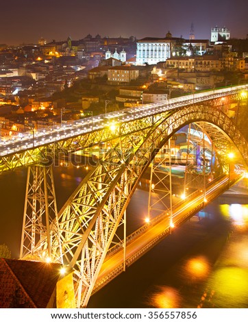 Dom Luis I bridge at night. Old Town of Porto on the background. Portugal