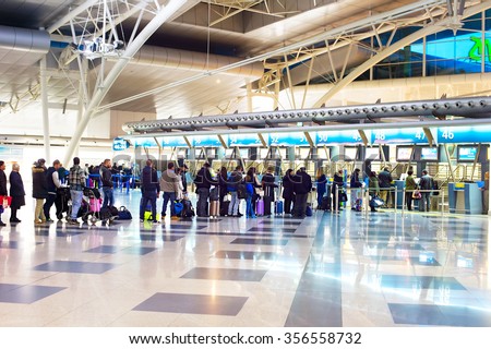 PORTO, PORUTGAL - JAN 16, 2015: People waiting in queue at a check-in counter in Francisco Sa Carneiro Airport. The airport was originally built in the 1940s