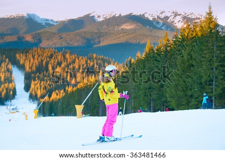 BUKOVEL, UKRAINE - DEC 08, 2015: Unidentified young girl skiing at ski resort in Bukovel. Bukovel is the most popular ski resort in Ukraine, in 2012 was named the fastest-growing world ski resort