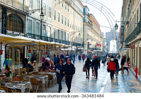 LISBON, PORTUGAL - DEC 24, 2014: People on Augusta street with the Triumphal Arch, the famous tourist attraction in Lisbon.