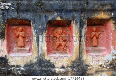 religious symbols in a stone facade