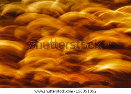 Golden orange and black fire and spark abstract background.