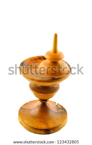 Spinning top made Ã?Â¢??Ã?Â¢??of wood spinning on a special stand carved out of wood