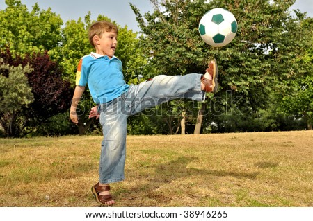 The boy from all force kicks the ball with his foot