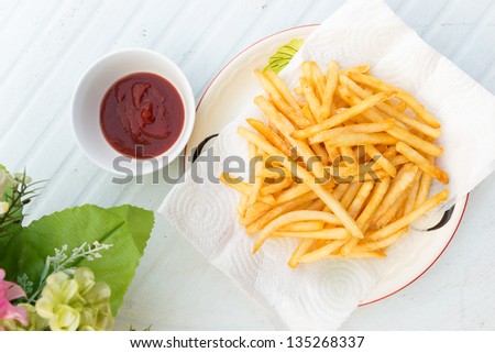 French Fries and flower on a table